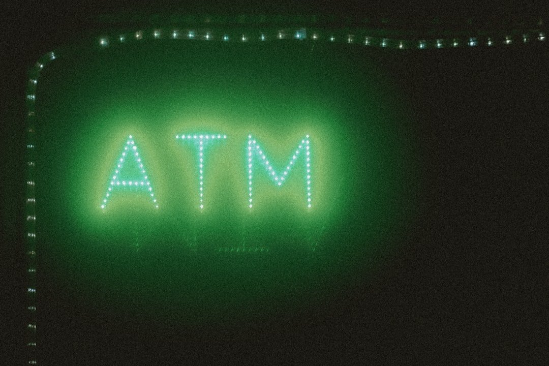 The image shows a glowing atm sign.