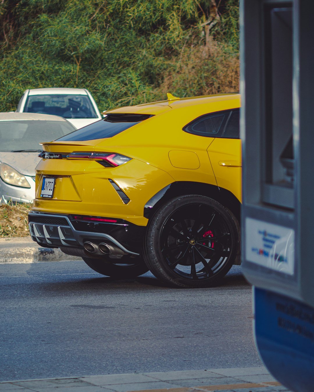 a yellow sports car parked on the side of the road