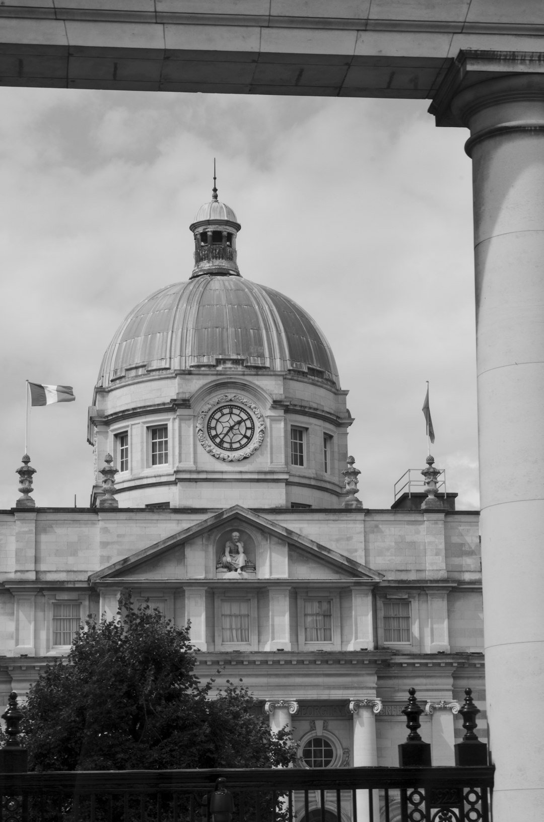A black and white photo of a building with a clock tower