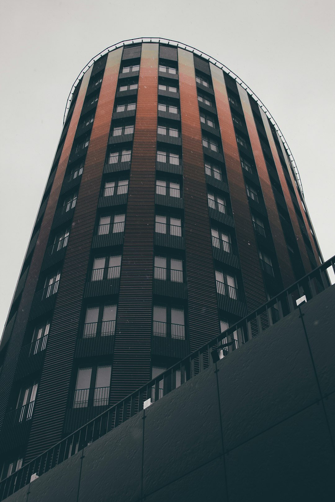 low-angle photography of brown building under white sky