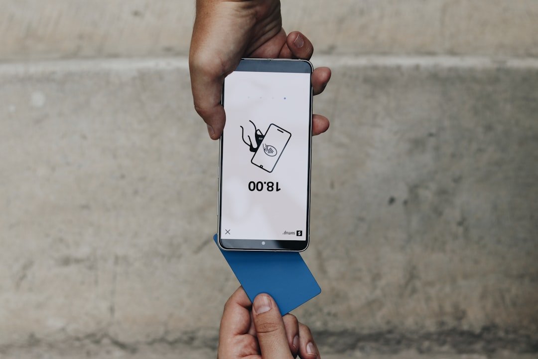 A person holding a box with a cat on it