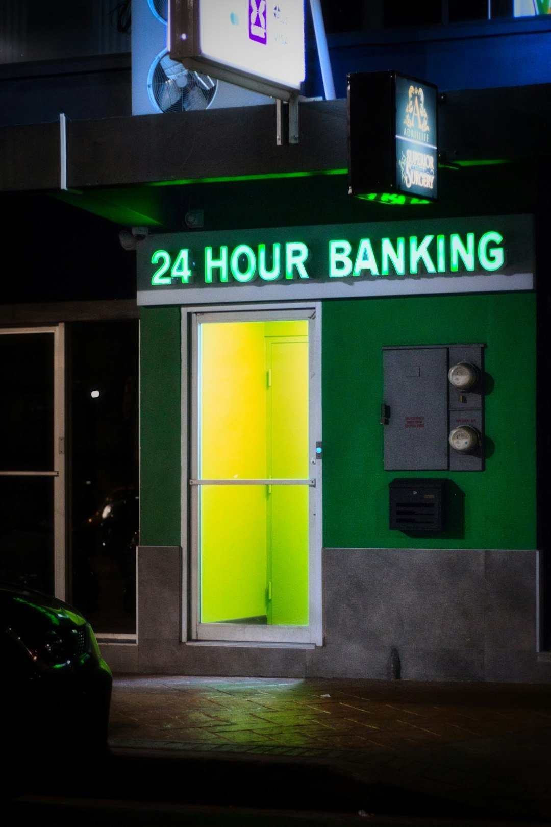 24 hour banking entrance with green and yellow lights