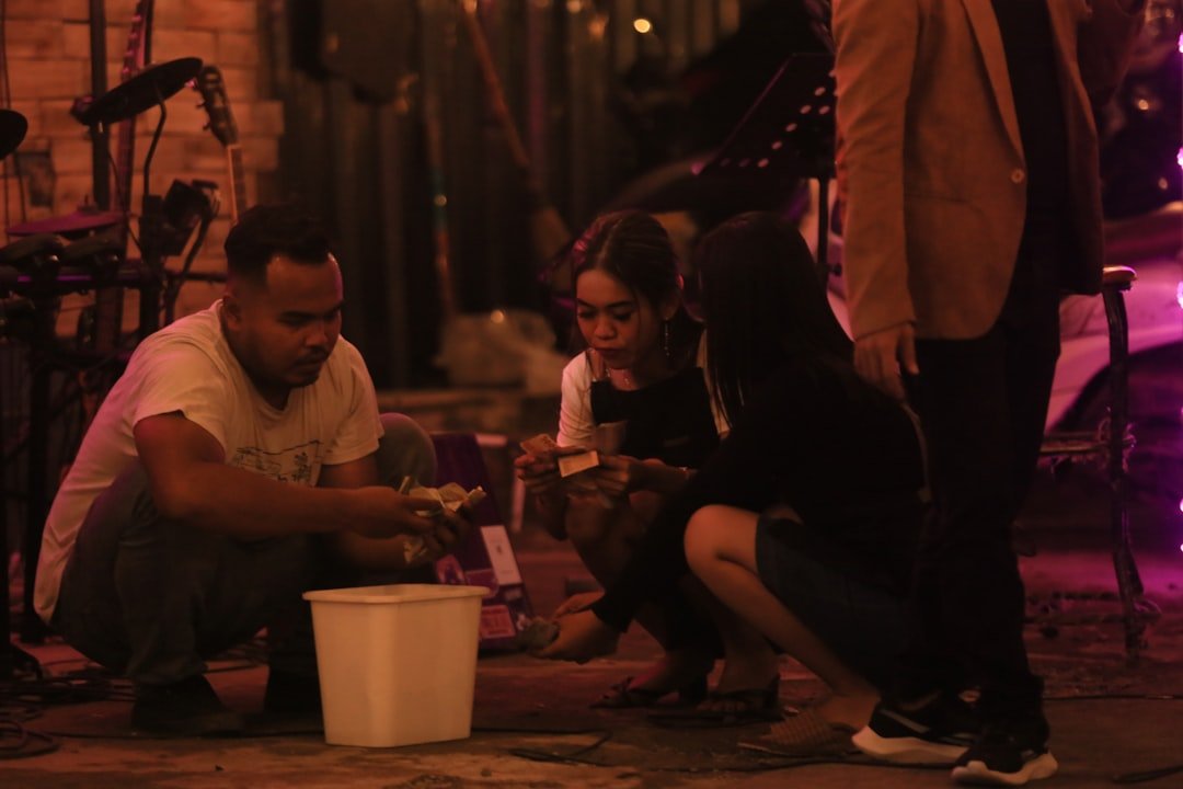 People gathered around a man working with a bucket.