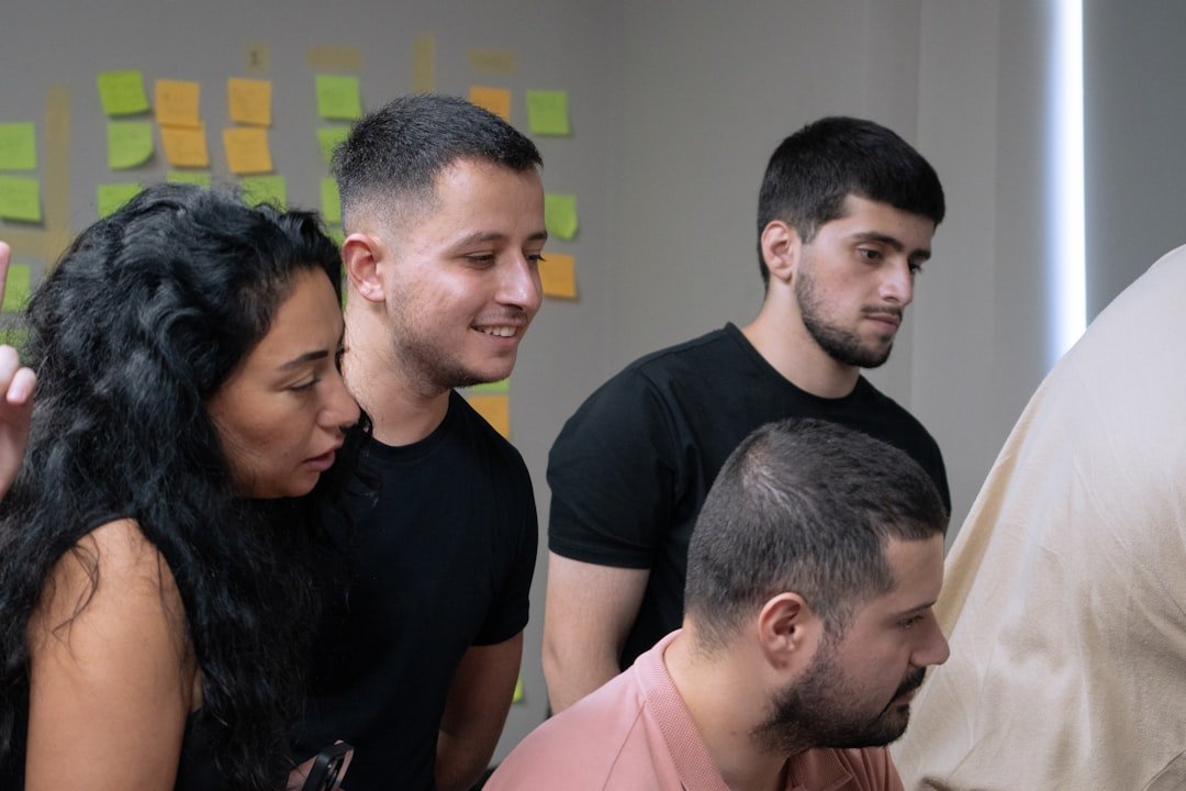 A group of people looking at a computer screen