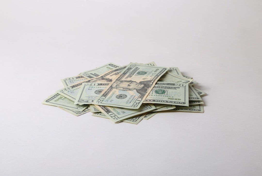 a pile of money sitting on top of a white table