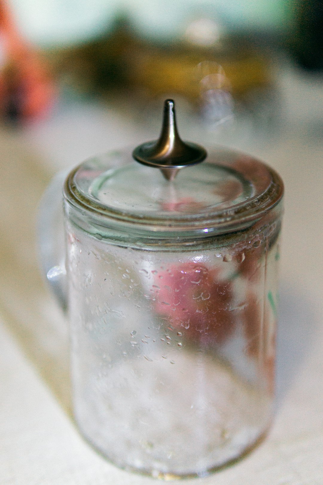 a glass jar filled with liquid sitting on top of a table