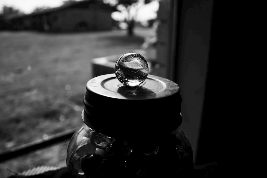 a glass ball sitting on top of a jar