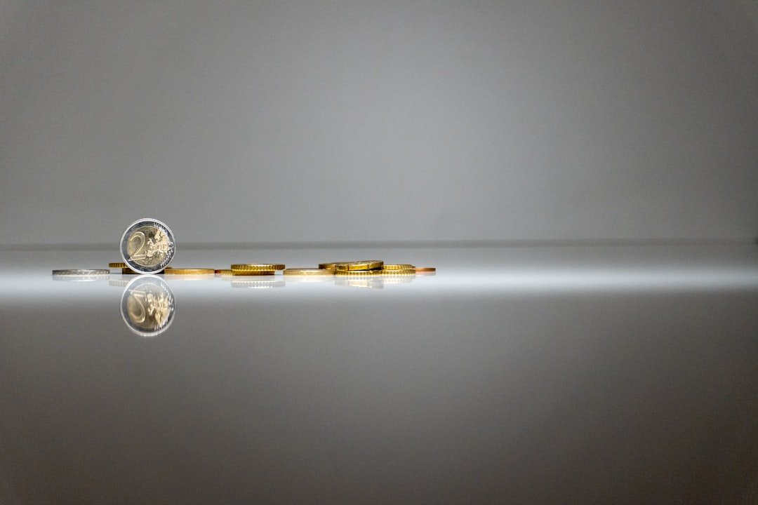 a silver and gold object with a reflection in the water