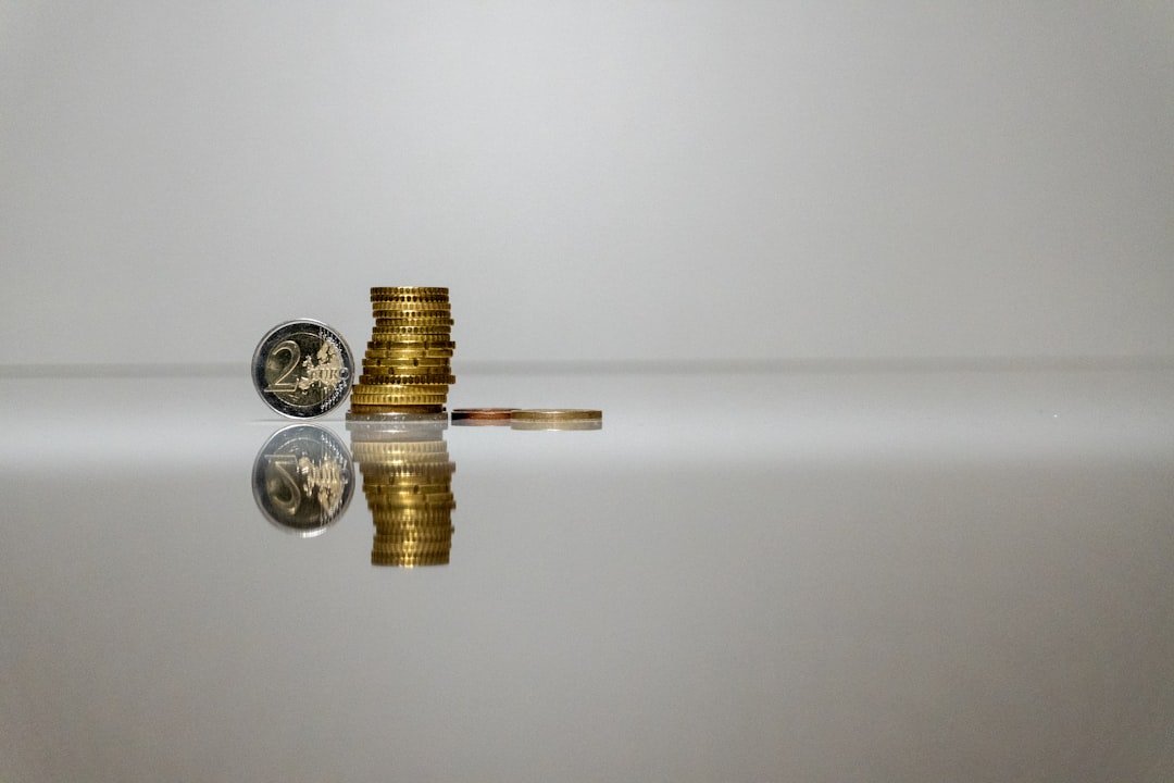 a stack of coins sitting on top of a reflective surface